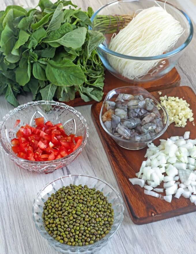 dried munggo beans, chopped tomatoes, onions, garlic, shrimp, sotanghon, and spinach