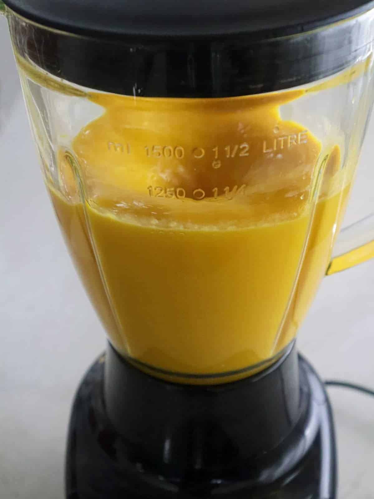 pureeing mango in a blender