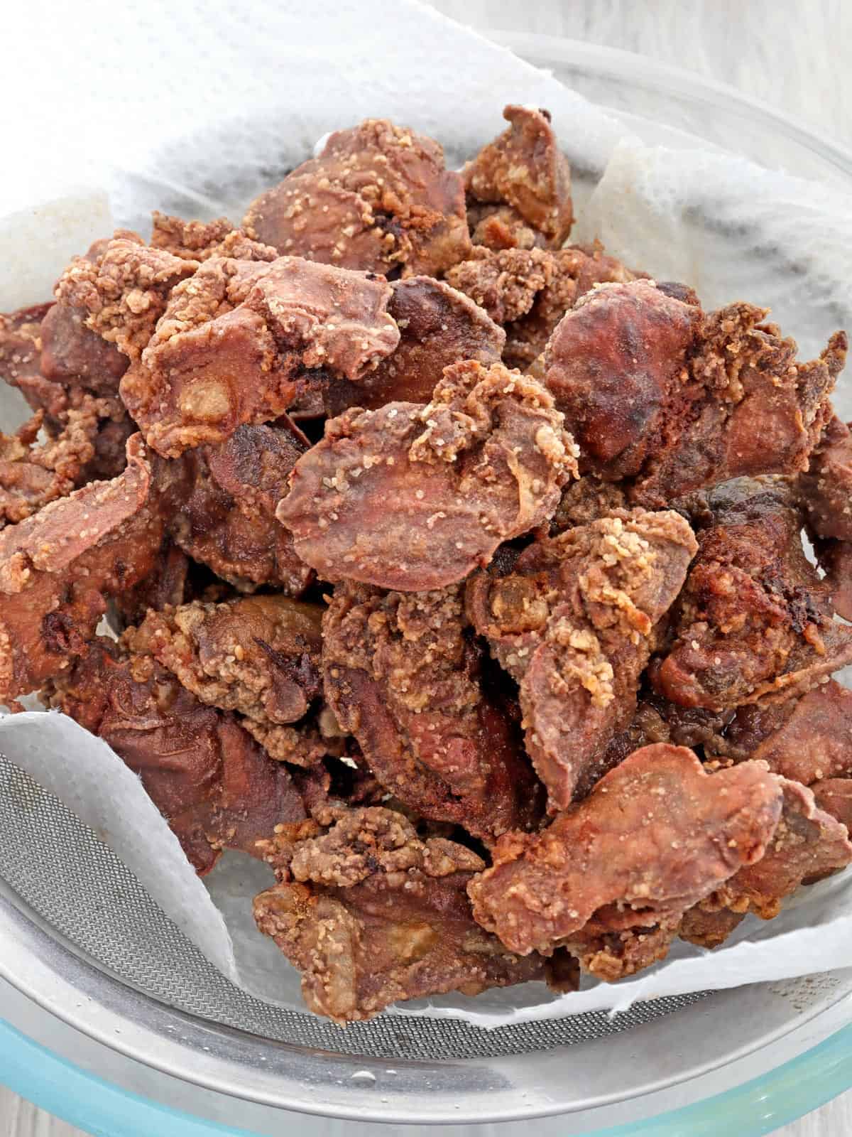 crispy fried chicken livers on a paper-lined plate