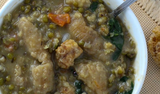 munggo soup with chicharon in a white serving bowl