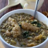 serving mung bean stew with crispy pork cracklings from a white serving bowl