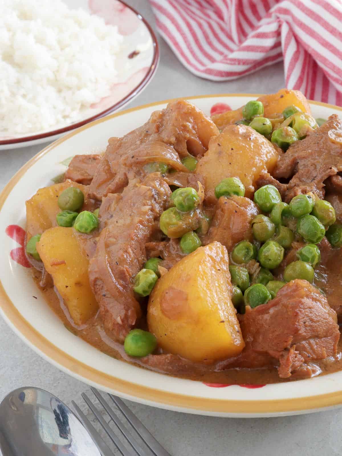 Pork kaldereta a la Quezon Province in a white serving bowl