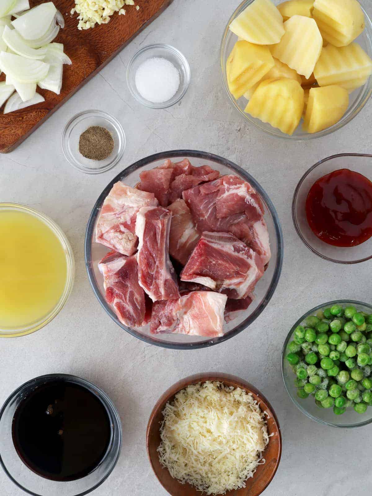 pork spareribs, green peas, pineapple chunks, pineapple juice, ketchup, shredded cheese in individual bowls