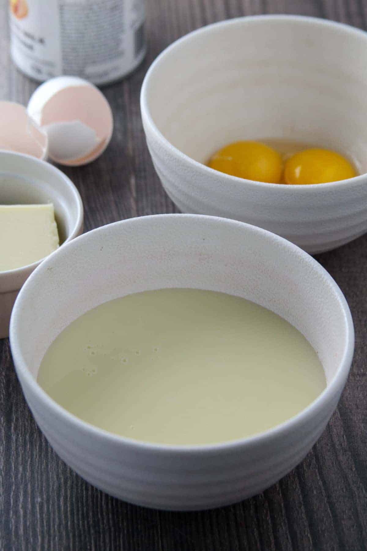 condensed milk, butter, and egg yolks in separate bowls