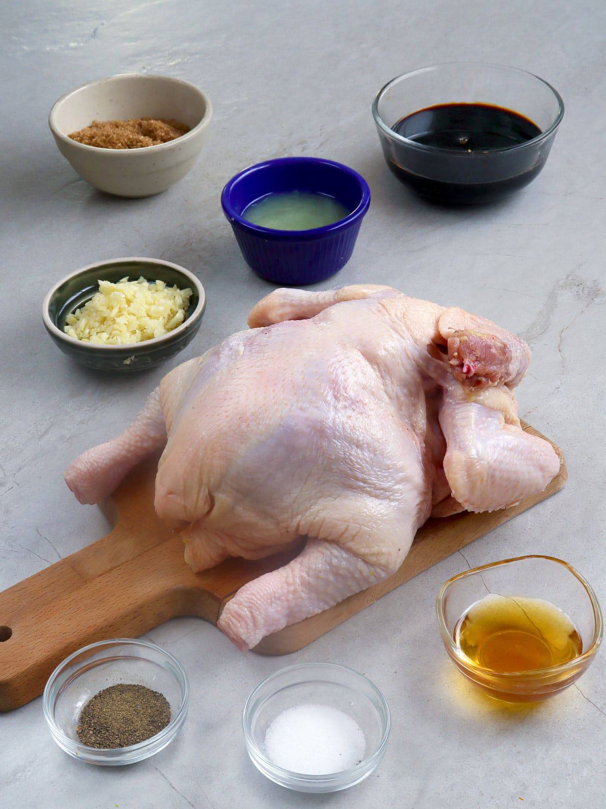 whole chicken, minced garlic, salt, pepper, soy sauce, brown sugar, calamansi juice