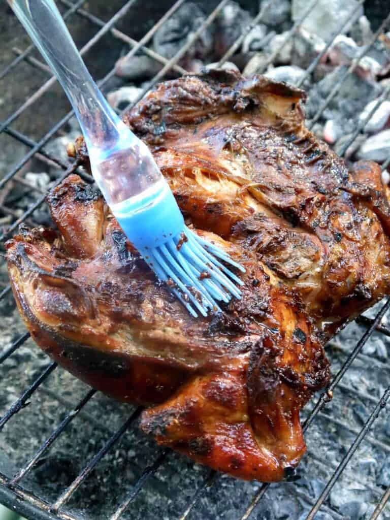 grilling whole chicken on charcoal