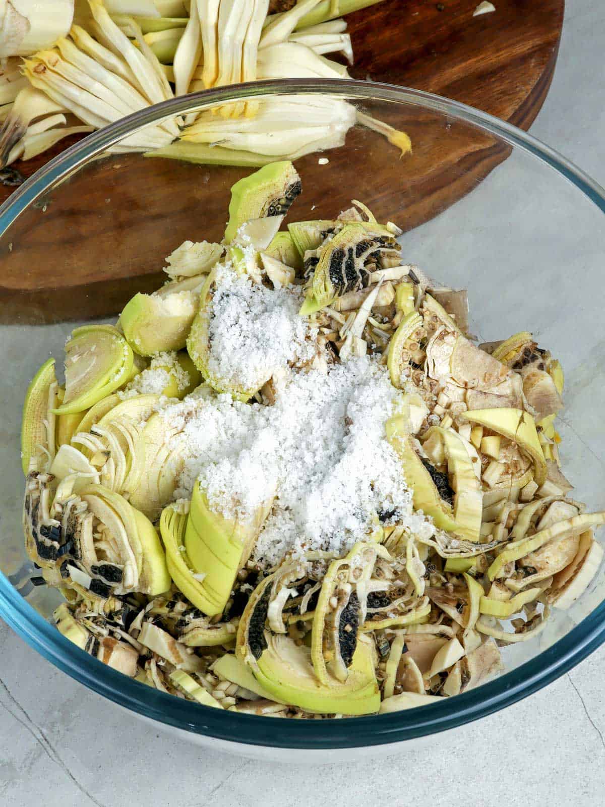 salting banana heart in a bowl