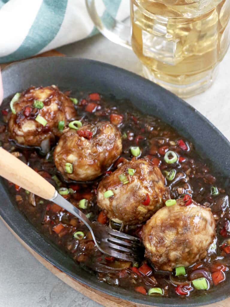 balut served sizzling style in a spicy and savory sauce
