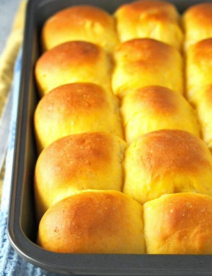 freshly-baked sweet potato bread rolls in a baking pan