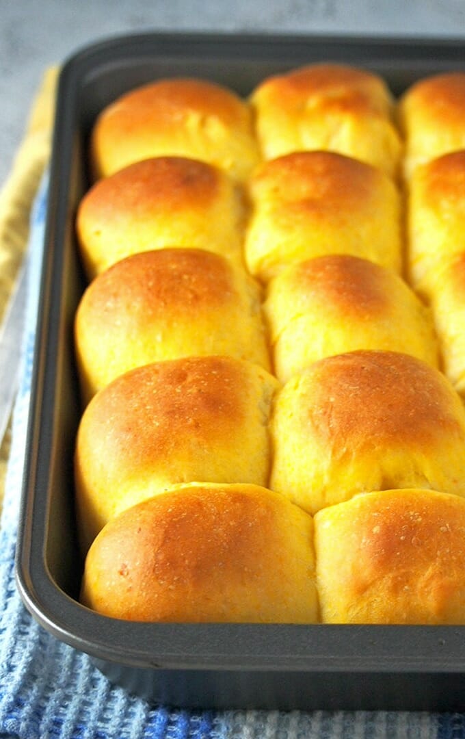 freshly-baked sweet potato bread rolls in a baking pan