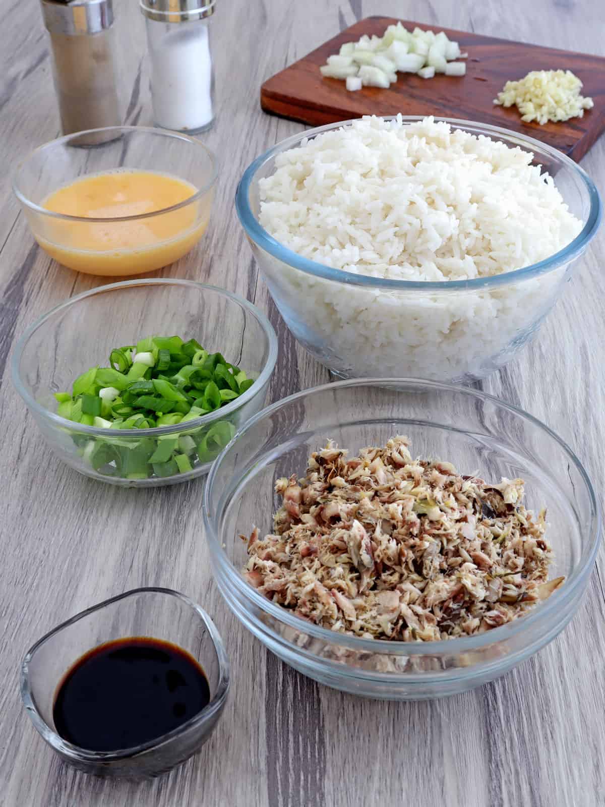 steamed rice, tinapa flakes, green onions, beaten eggs, soy sauce in individual bowls