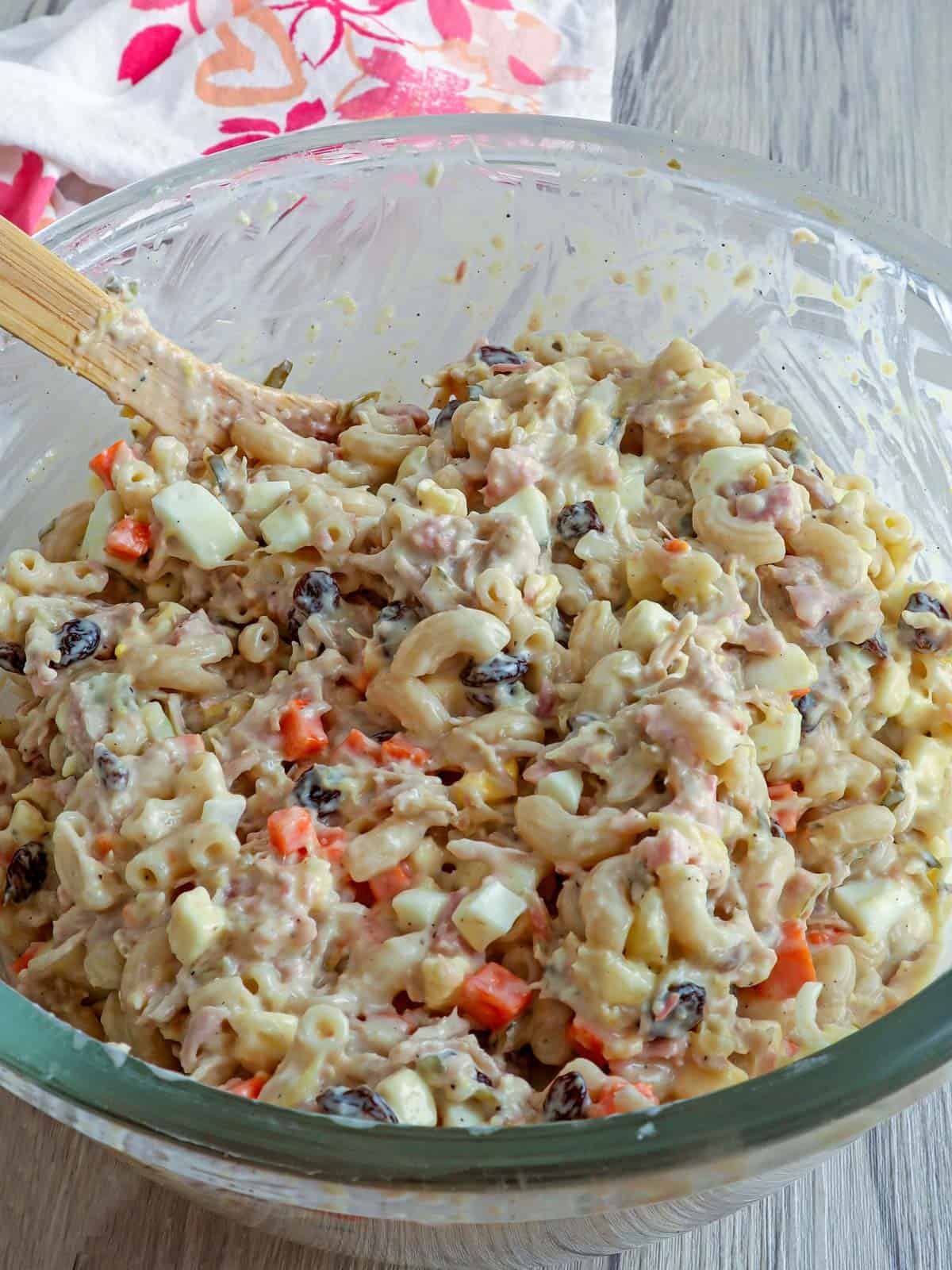 stirring together chicken macaroni in a bowl