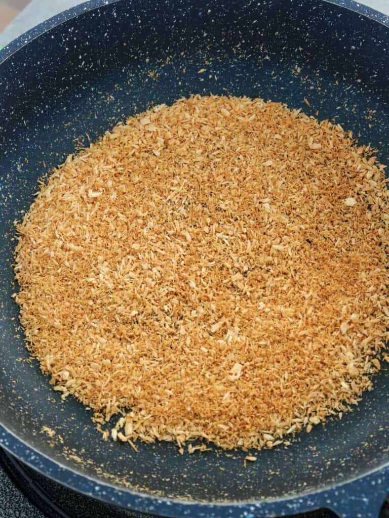 toasting shredded coconut in a skillet