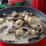 Beef in Creamy Mushroom Sauce in a red skillet