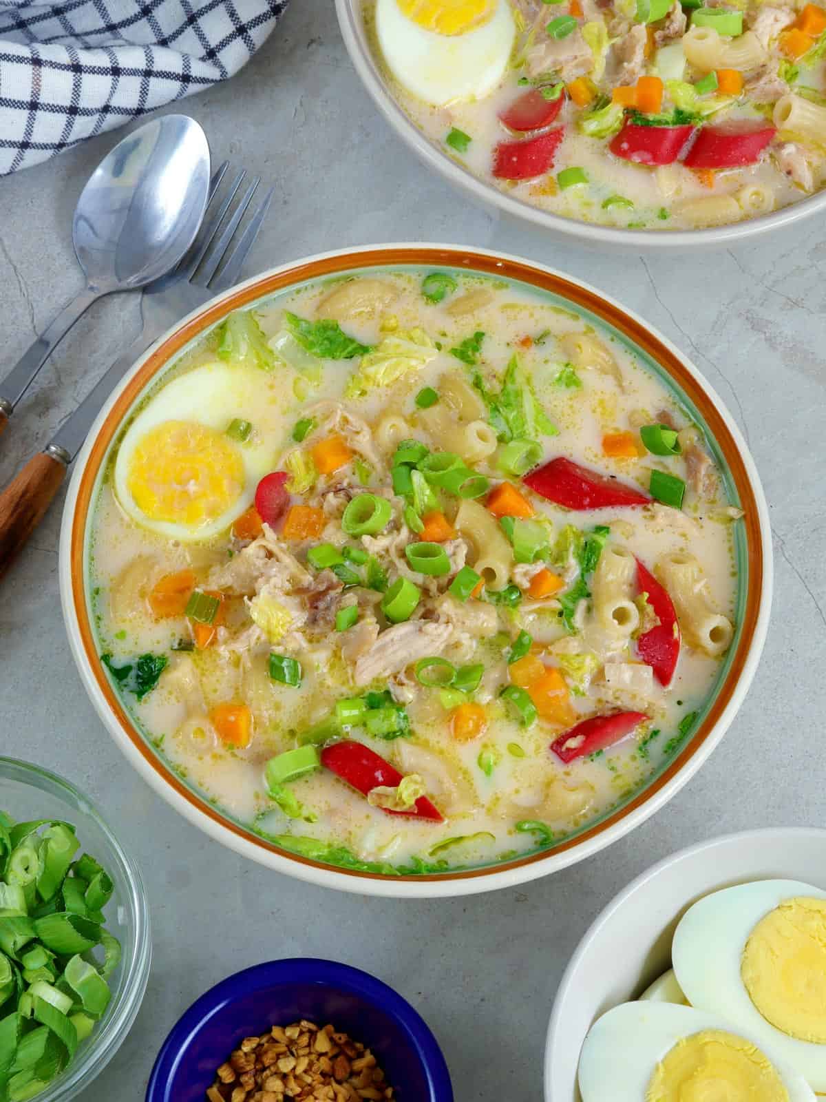 Chicken Sopas with eggs and hot dogs in a serving bowl