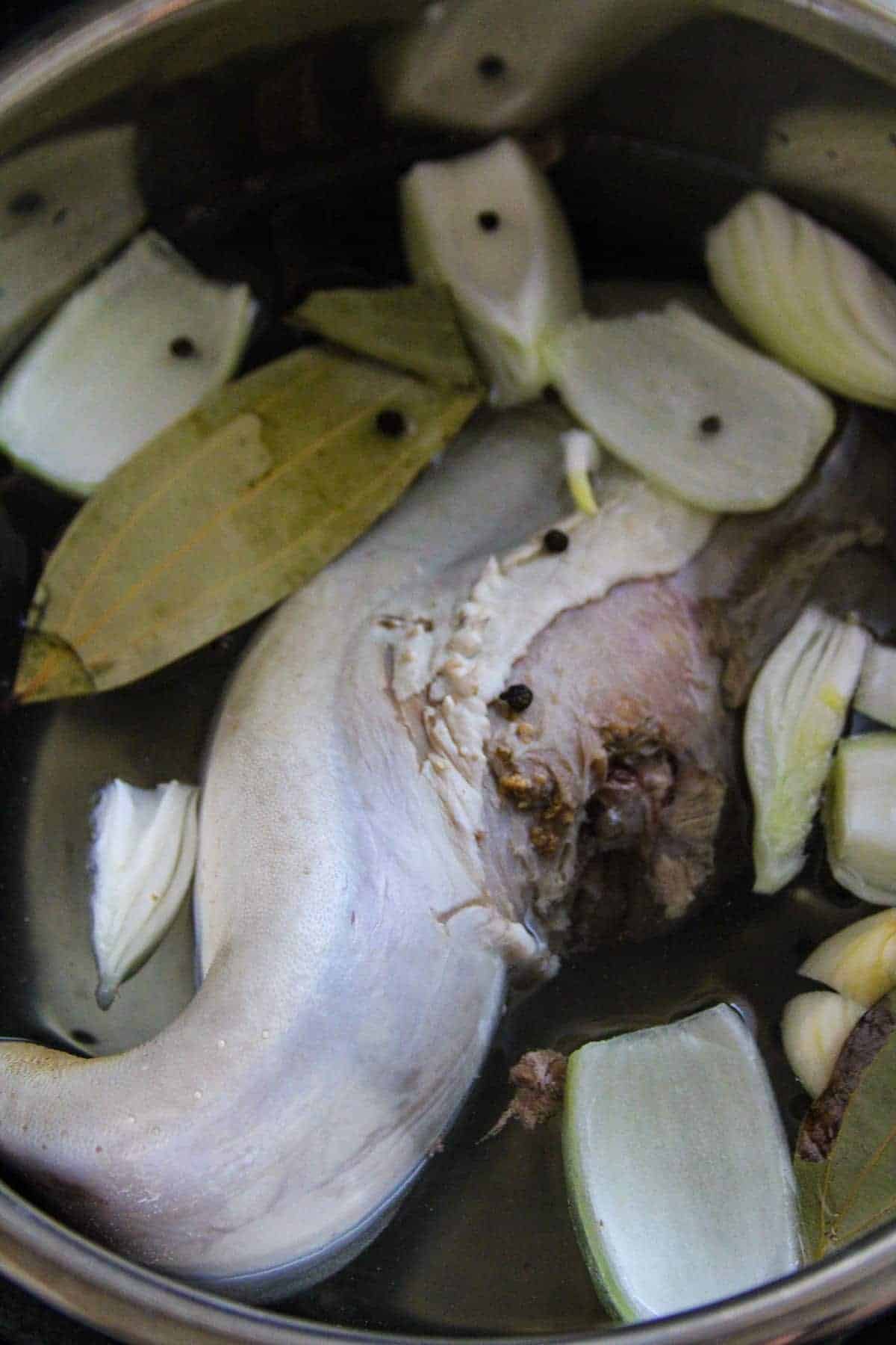 boiling tongue with aromatics in a pot