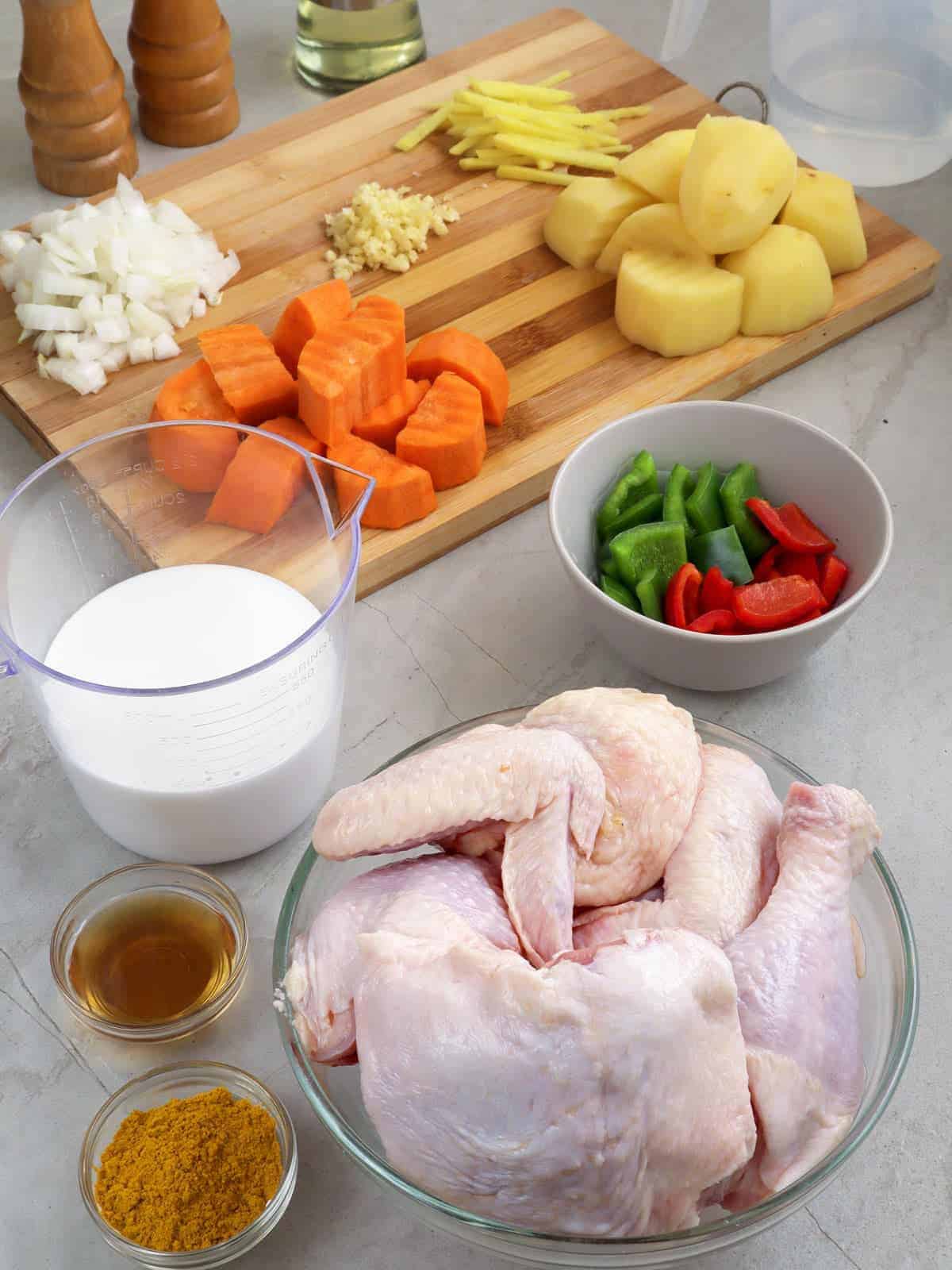 cut up bone-in chicken, peeled and cubed potatoes and carrots, coconut milk, curry powder, bell peppers