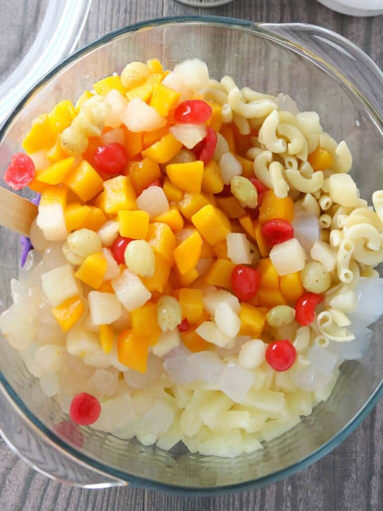 macaroni, fruit cocktail, kaong, and nata de coco, cheese in a bowl