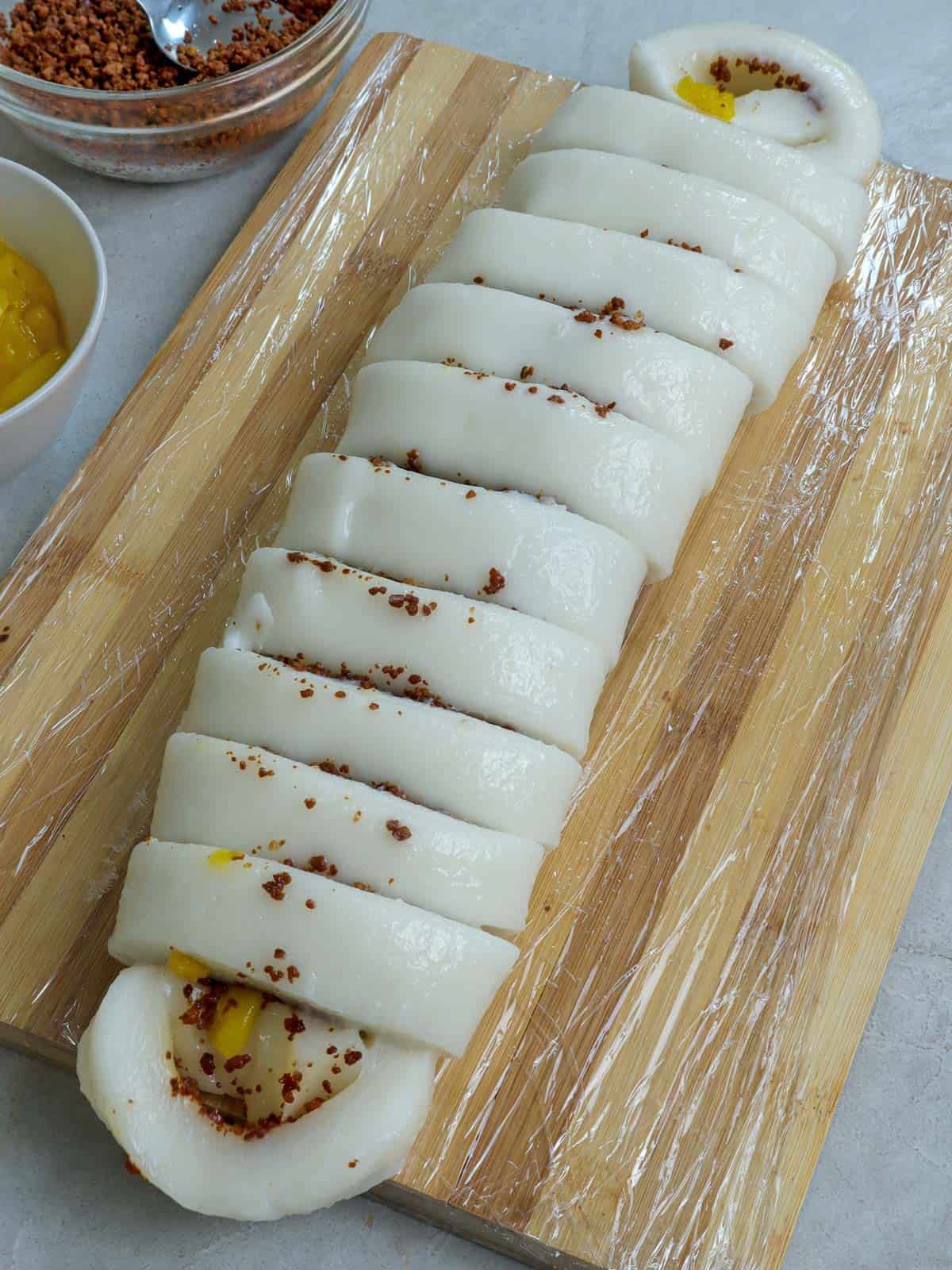 sliced rolled kapit on a cutting board.