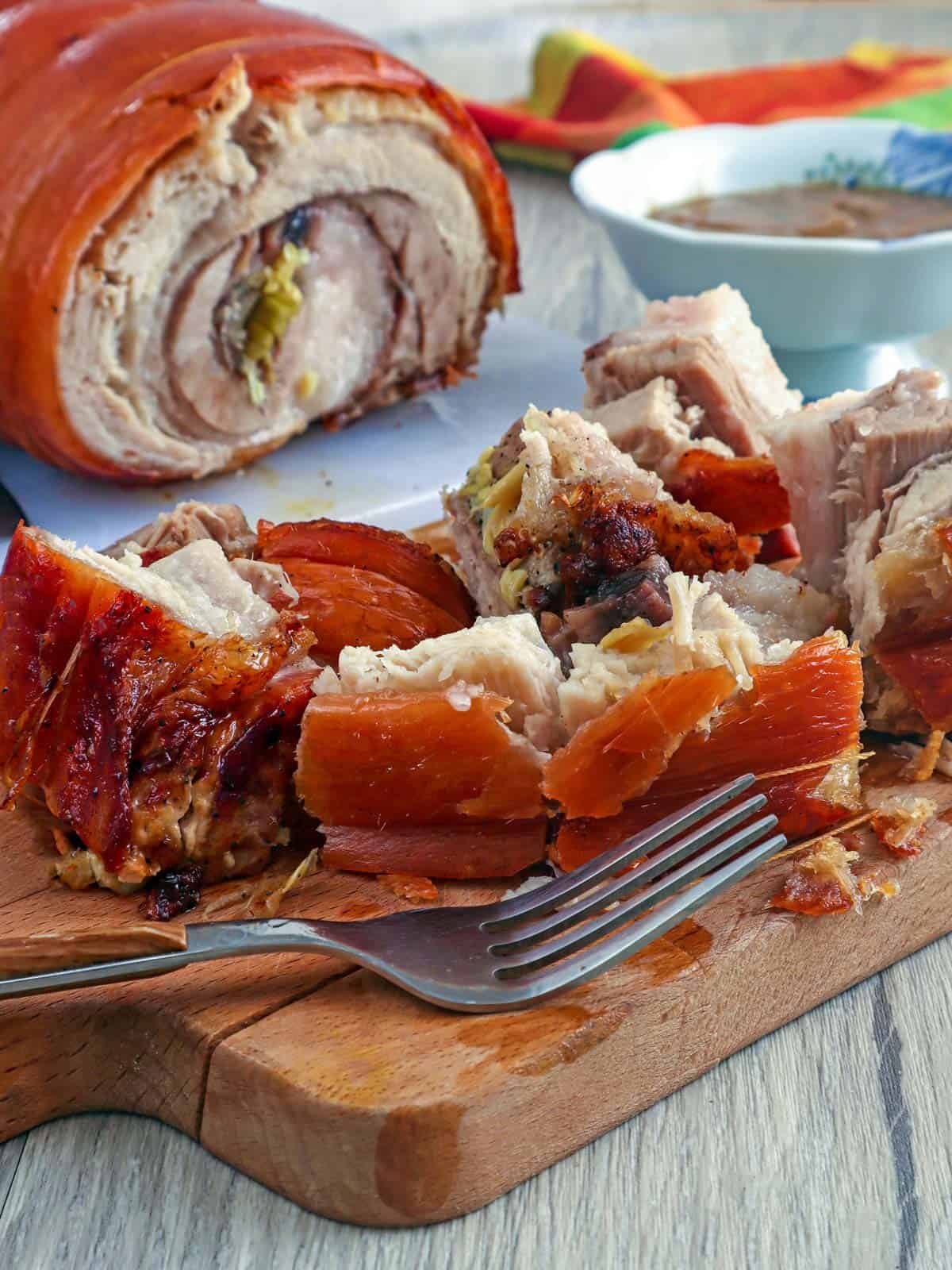 lechon pork belly on a cutting board
