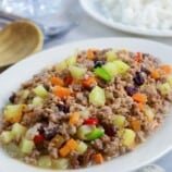 Giniling na Baboy on a white oblong serving platter with a side of steamed rice