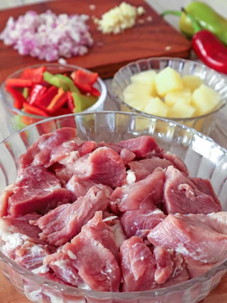 pork cubes, pineapple cubes, bell peppers, chopped onions, garlic