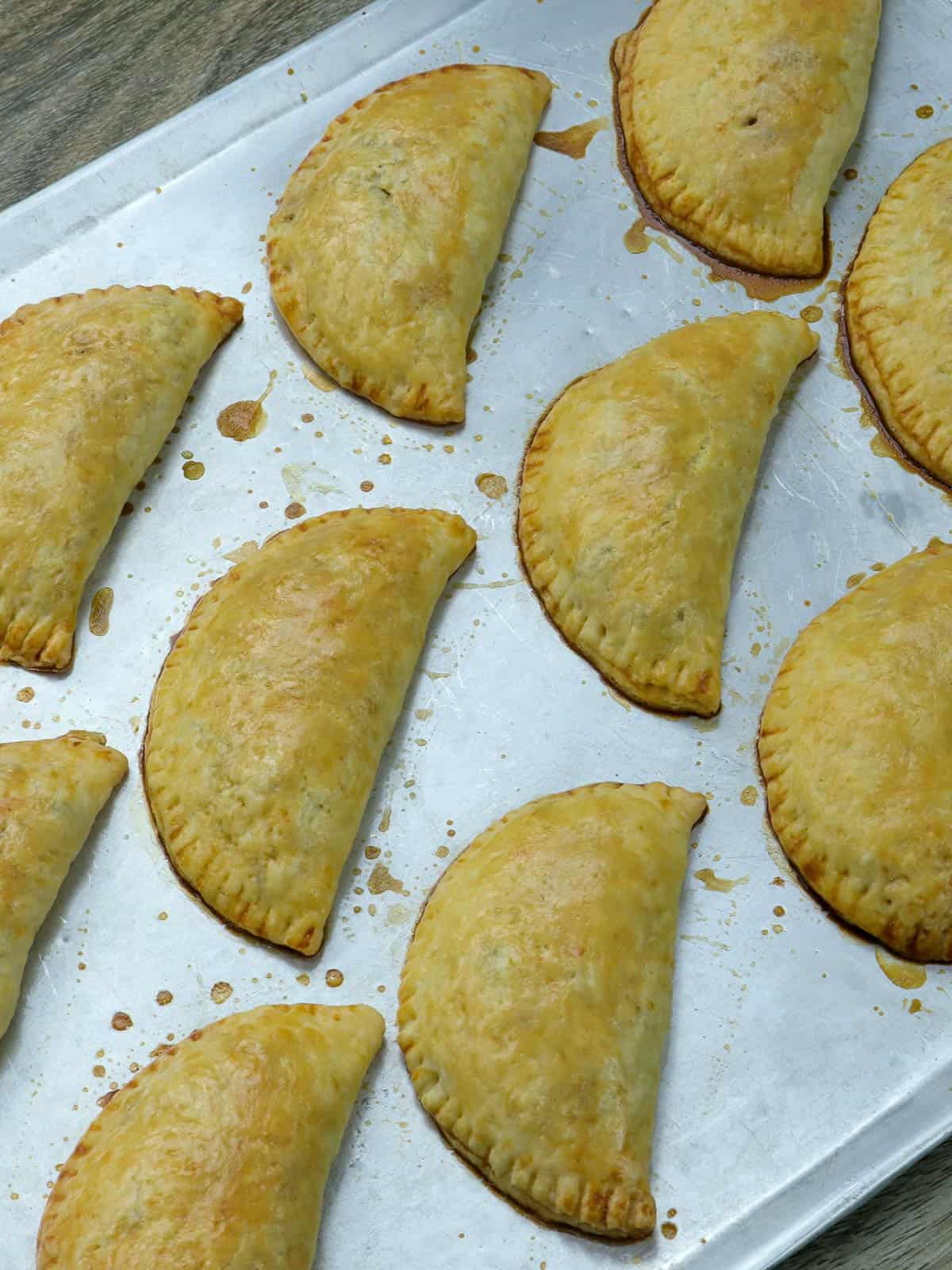 baked empanadas on a baking sheet