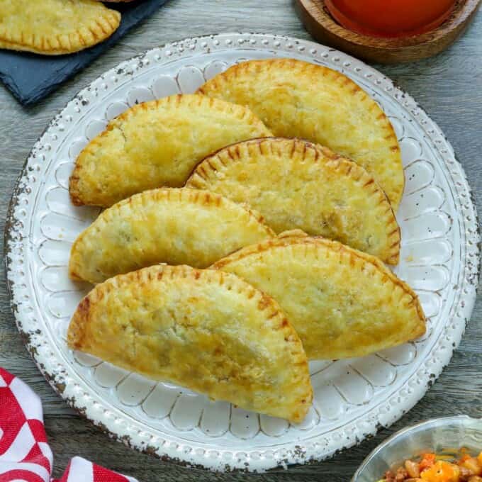 Filipino empanada with ground beef filling on a white plate