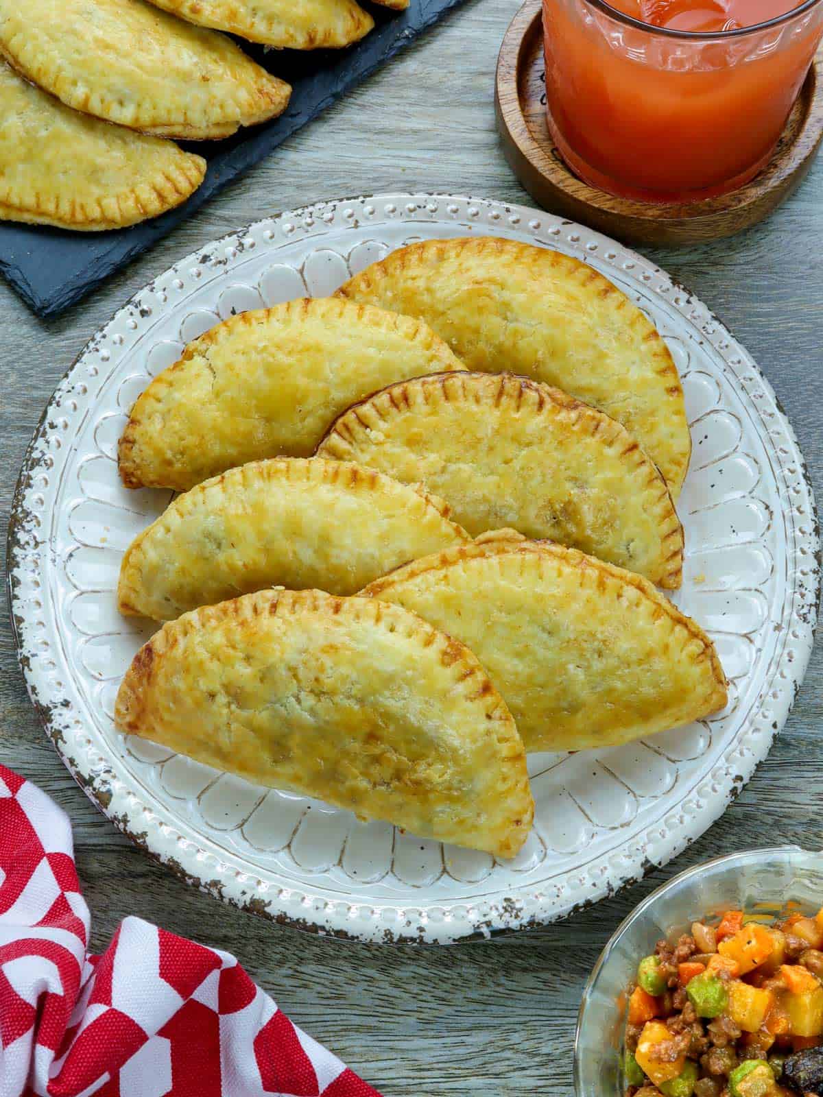 Filipino empanada with ground beef filling on a white plate