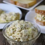 Chicken Salad Sandwich Spread in bowl with sliced bread on the side.