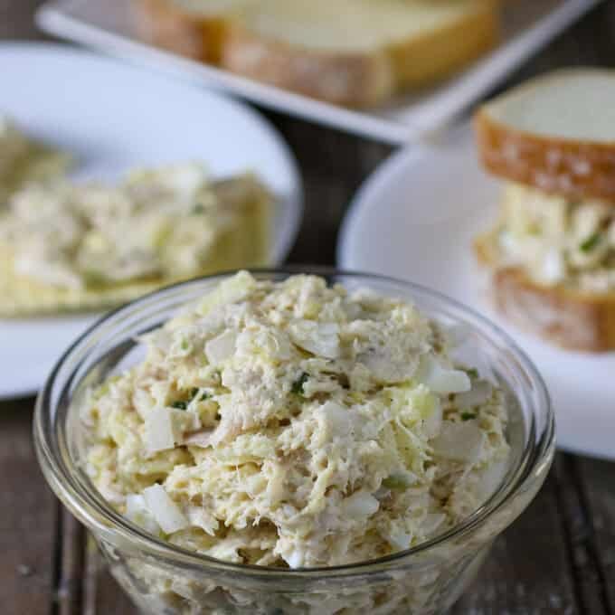 Chicken Salad Sandwich Spread in bowl with sliced bread on the side.