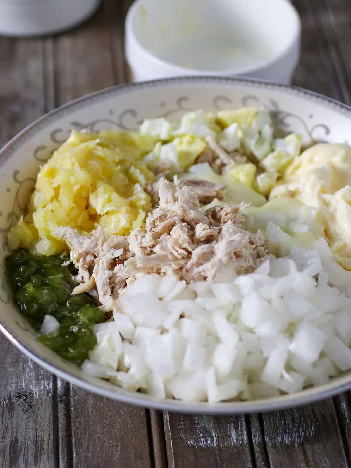 shredded chicken, chopped onions, eggs, sweet relish, and mayonnaise in a large bowl