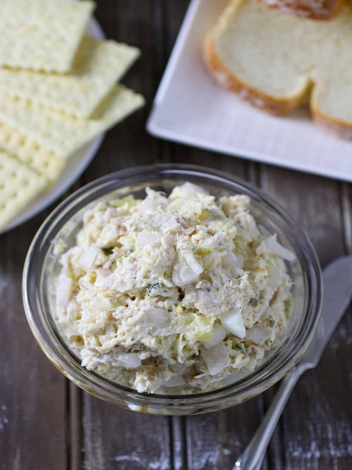 Chicken Salad Sandwich Spread in bowl with sliced bread on the side