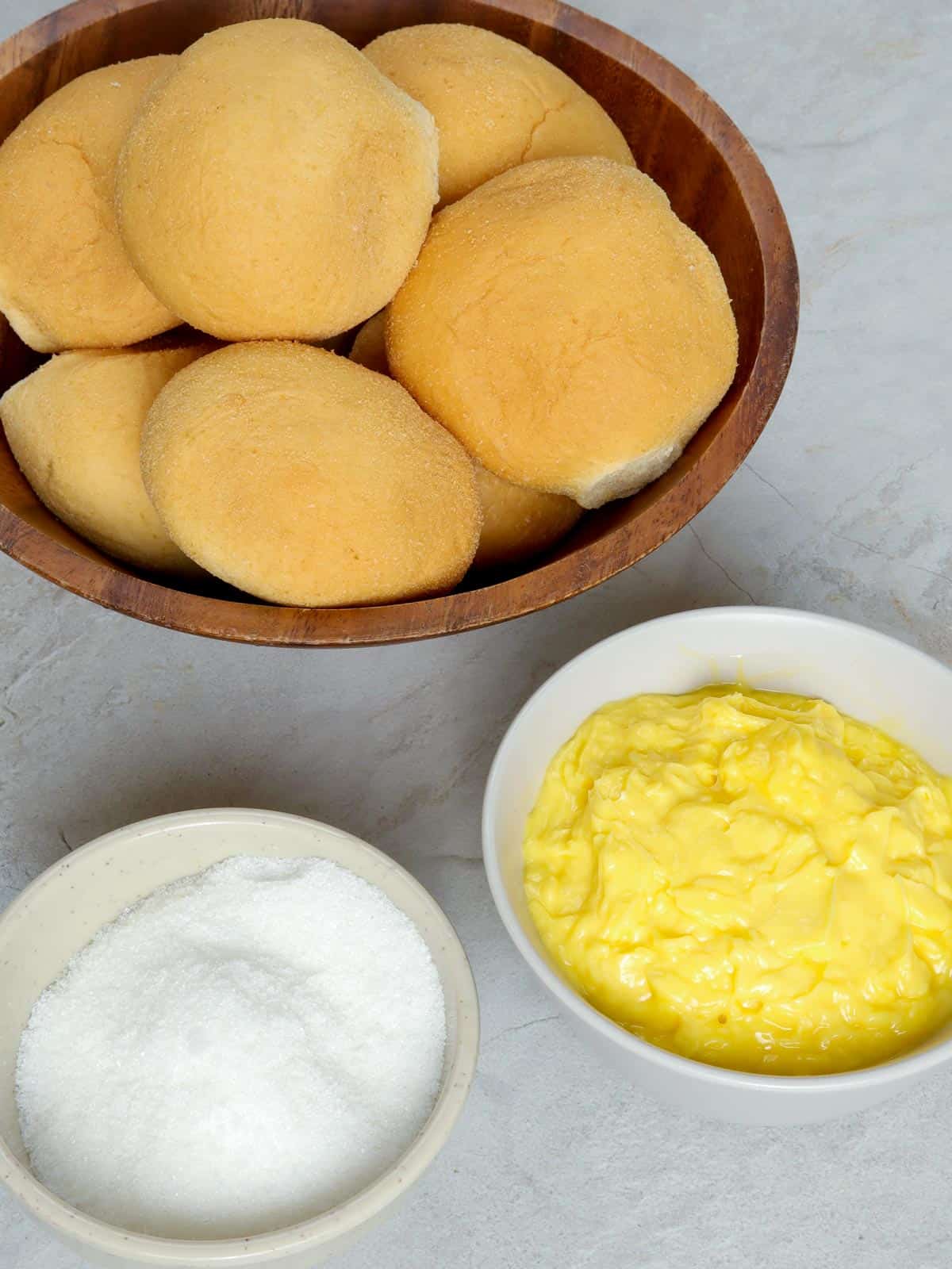 pandesal rolls, sugar, butter in bowls