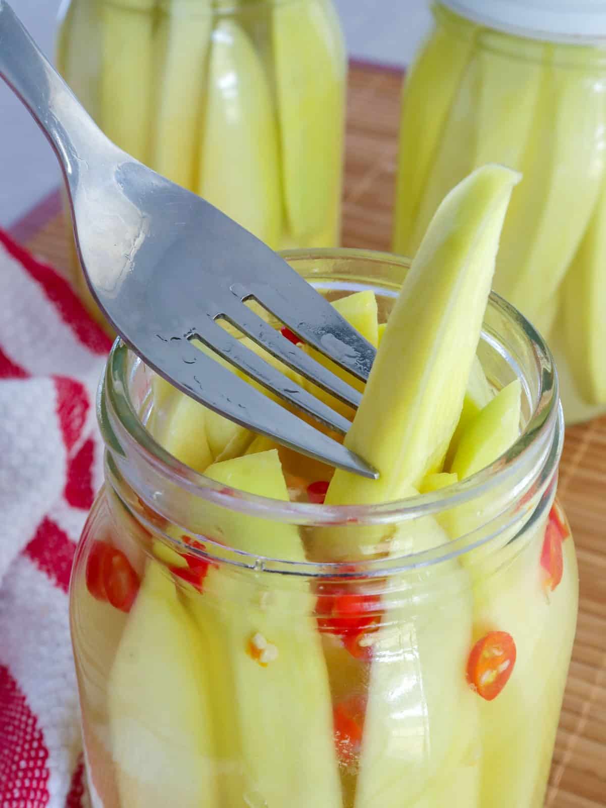 serving burong mangga with a fork from a jar