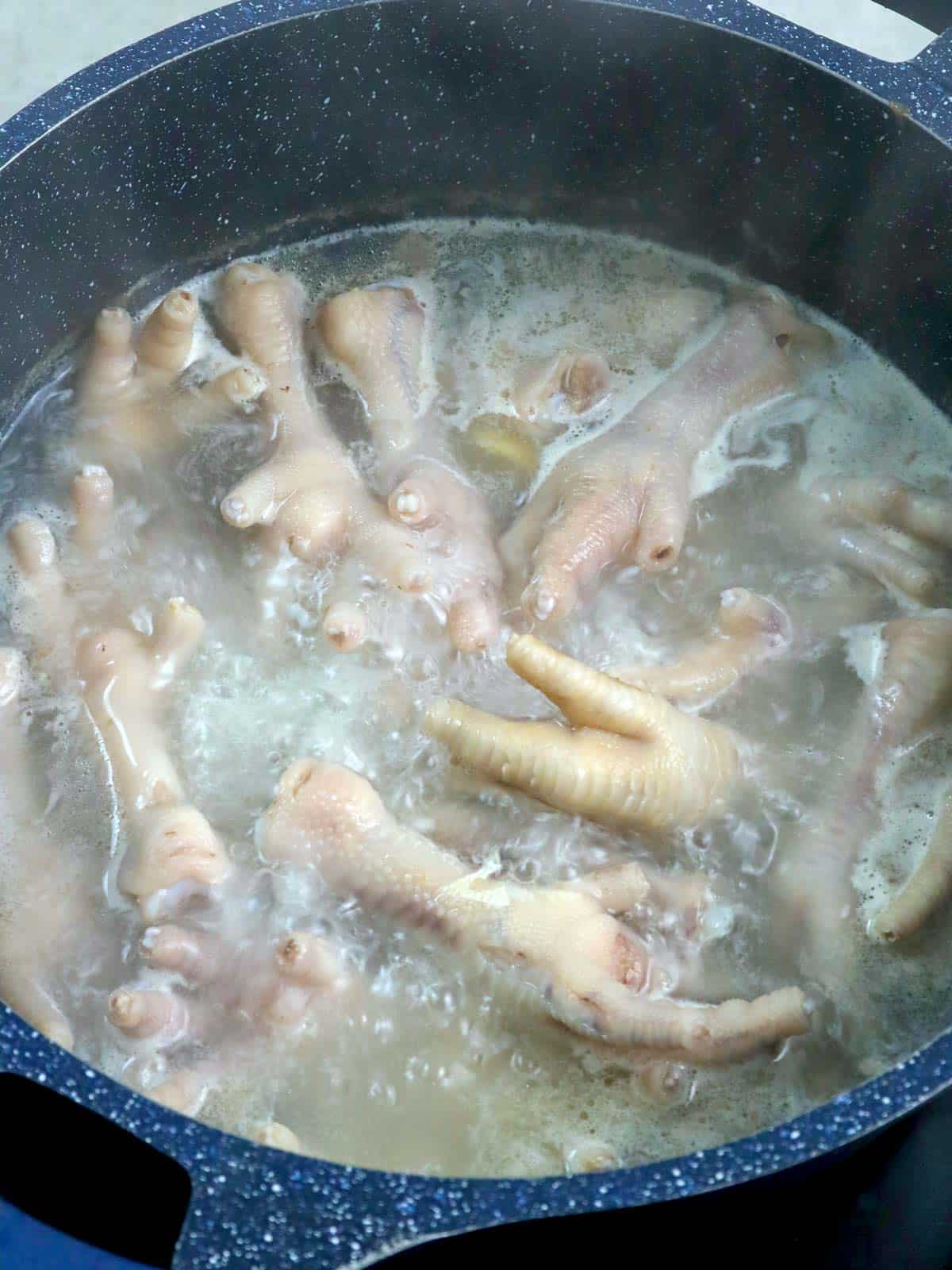 boiling chicken feet in a pot