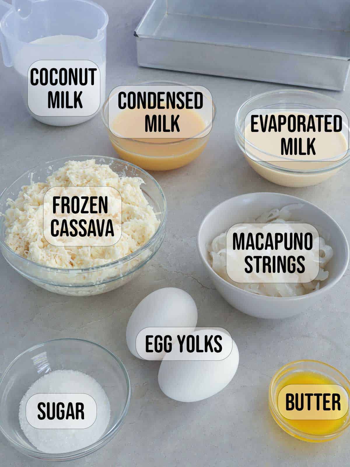 grated cassava, coconut milk, condensed milk, evaporated milk, macapuno, eggs, butter, sugar in bowls.