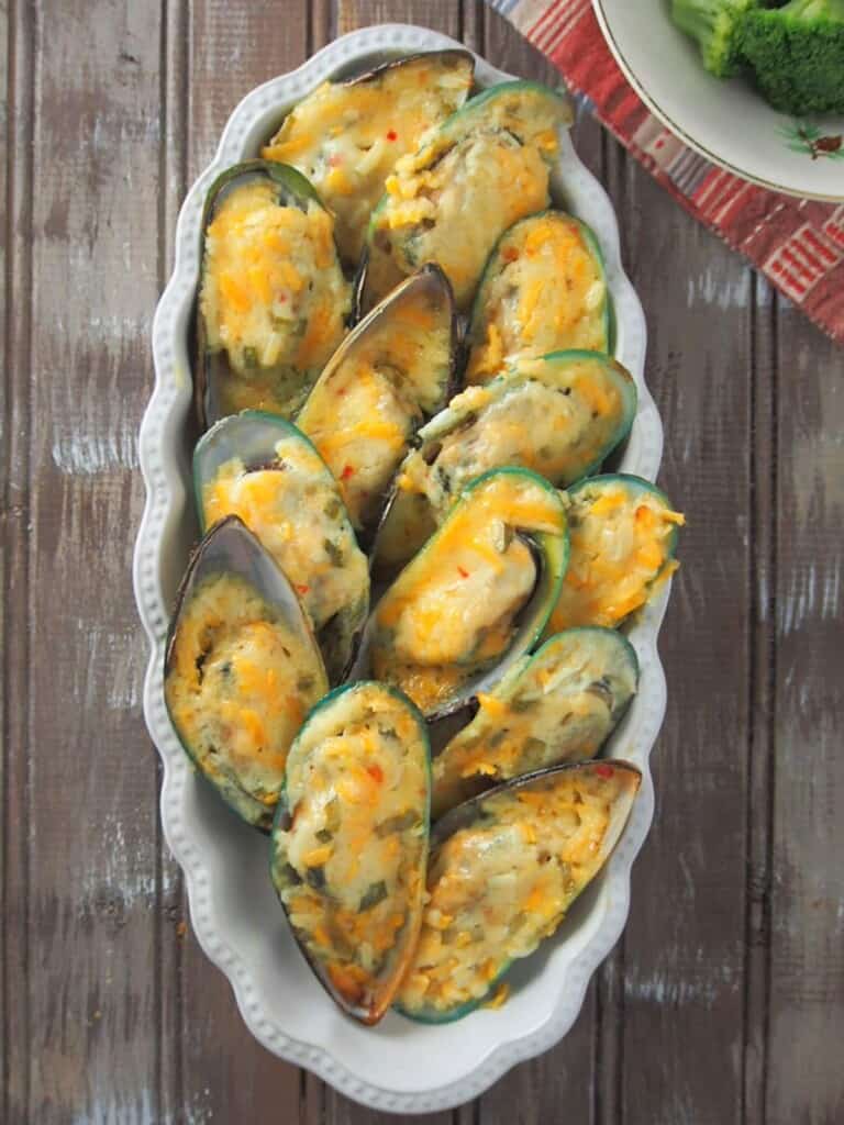 baked stuffed mussels in a white rectangular bowl