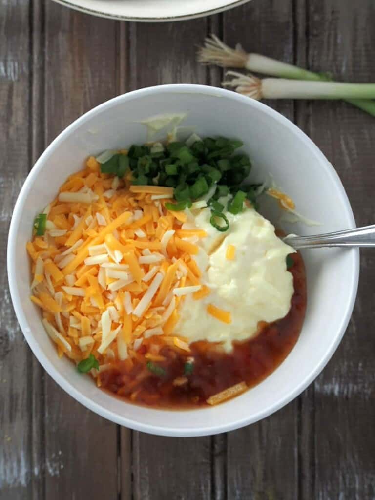 mayo, sweet chili sauce, shredded cheese, green onions, and lime juice in a bowl