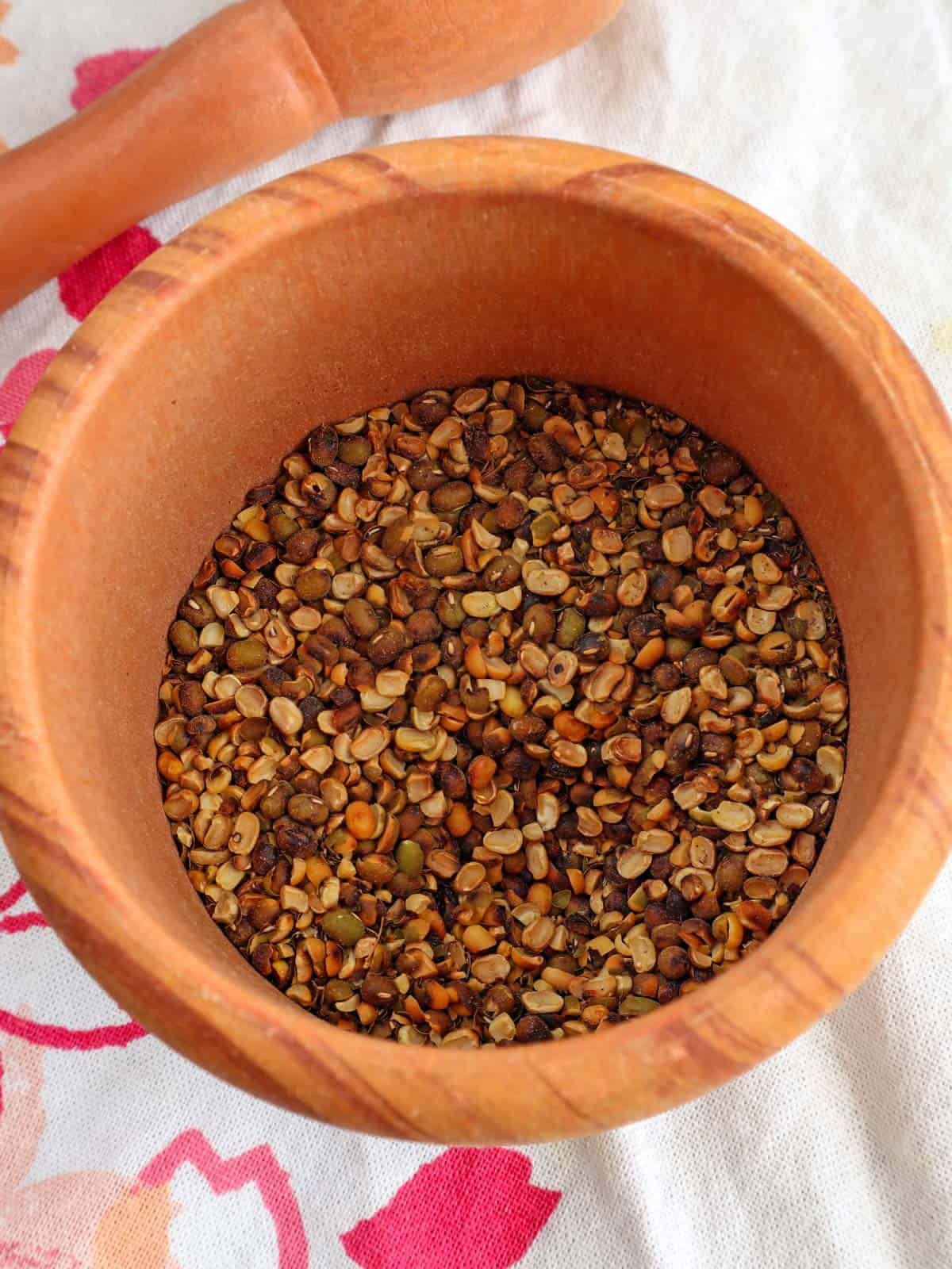 cracked toasted mung beans using a mortar and pestle