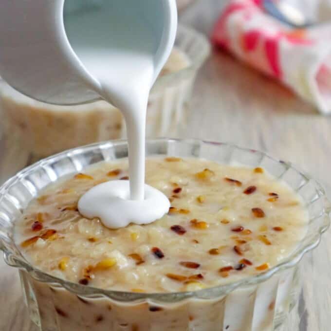 pouring coconut cream on ginataang tutong in a clear bowl