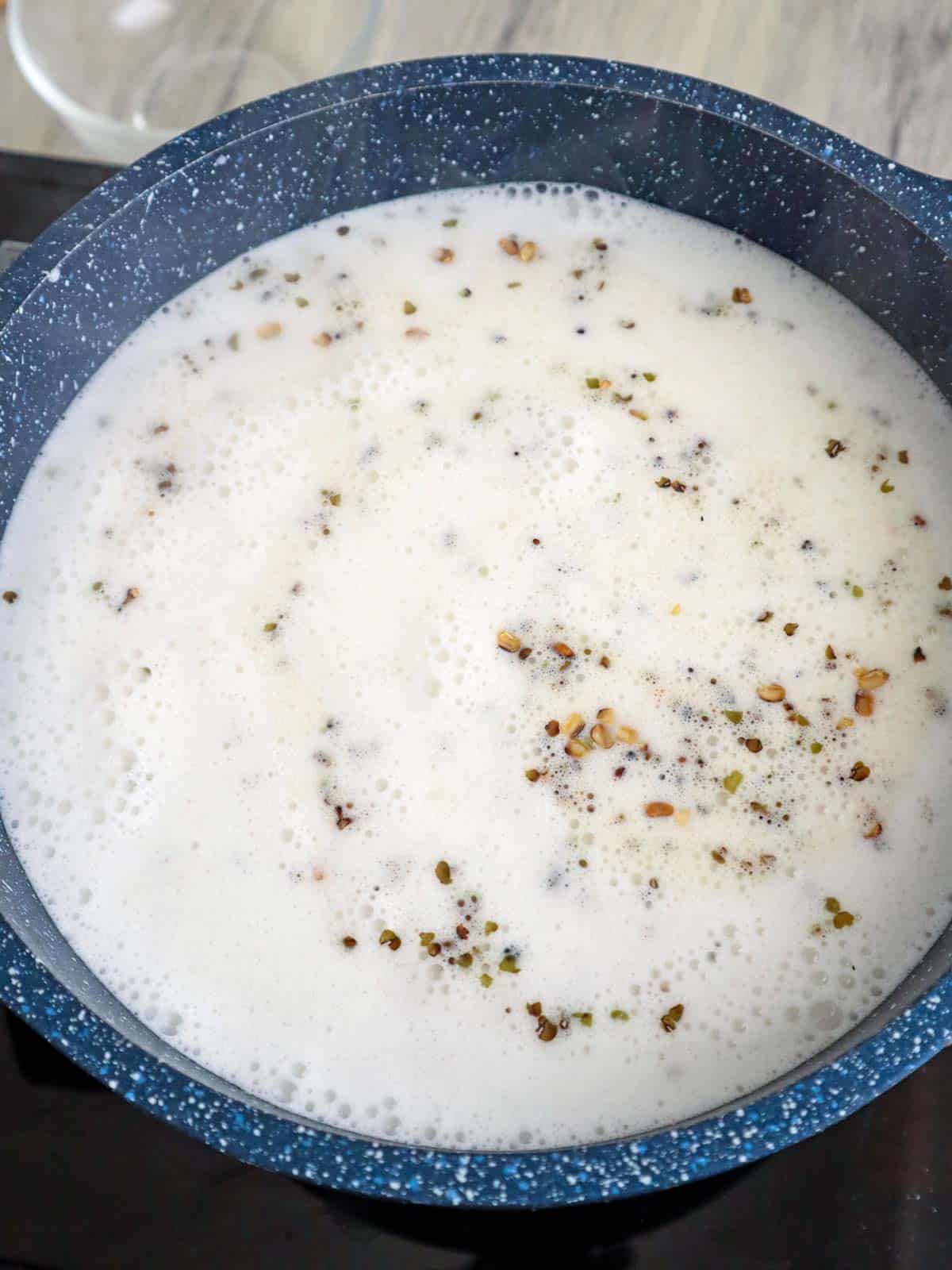 cooking ginataang tutong in a pot