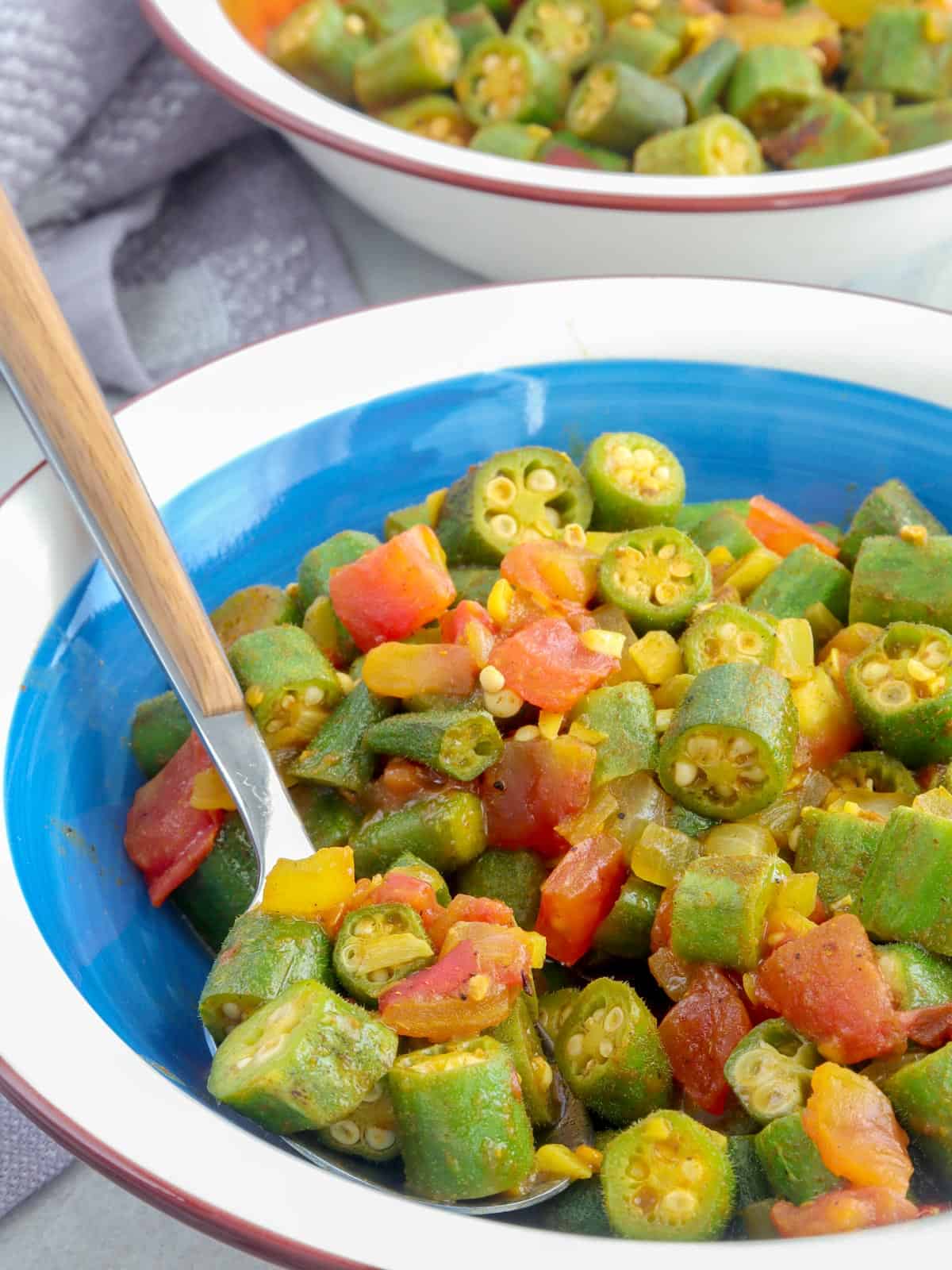 eating smothered okra and tomatoes in a bowl