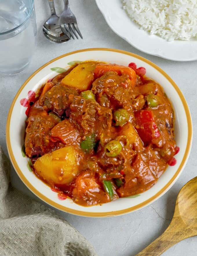 kalderetang baka in a white serving bowl