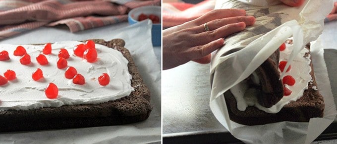 topping swiss roll cake with cherries and then rolling the cake into a log