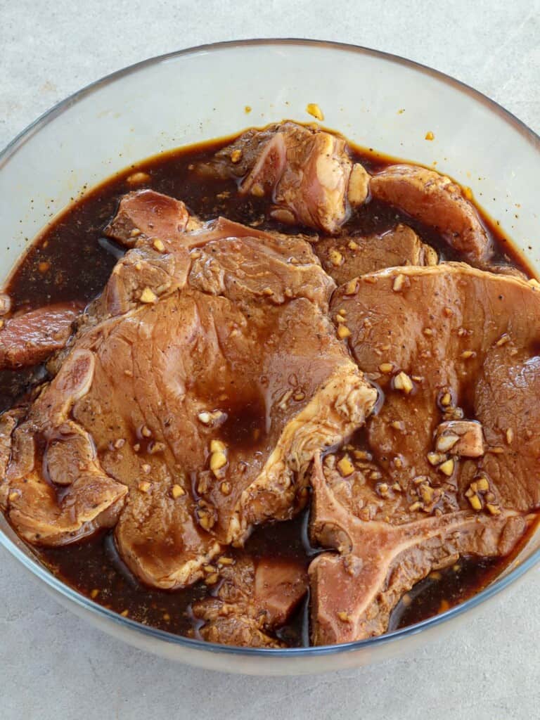 marinating pork chops in soy sauce and calamansi juice