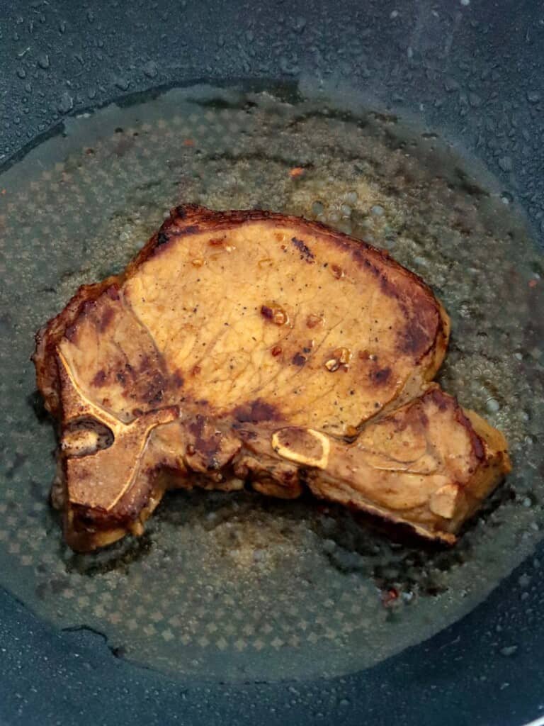 frying pork chops in a pan