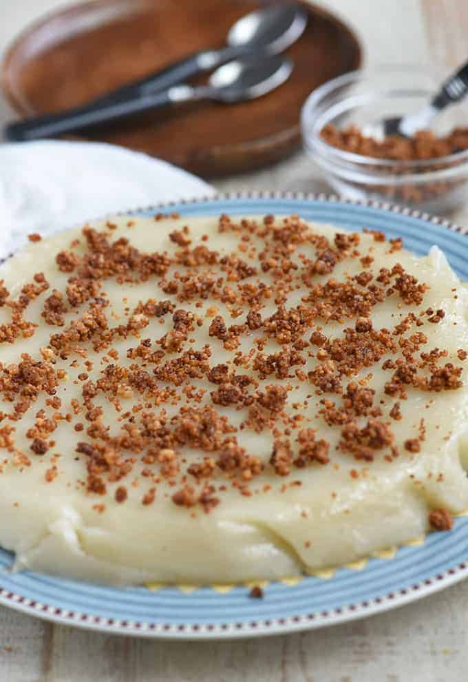 kalamay lansong topped with latik on a blue plate