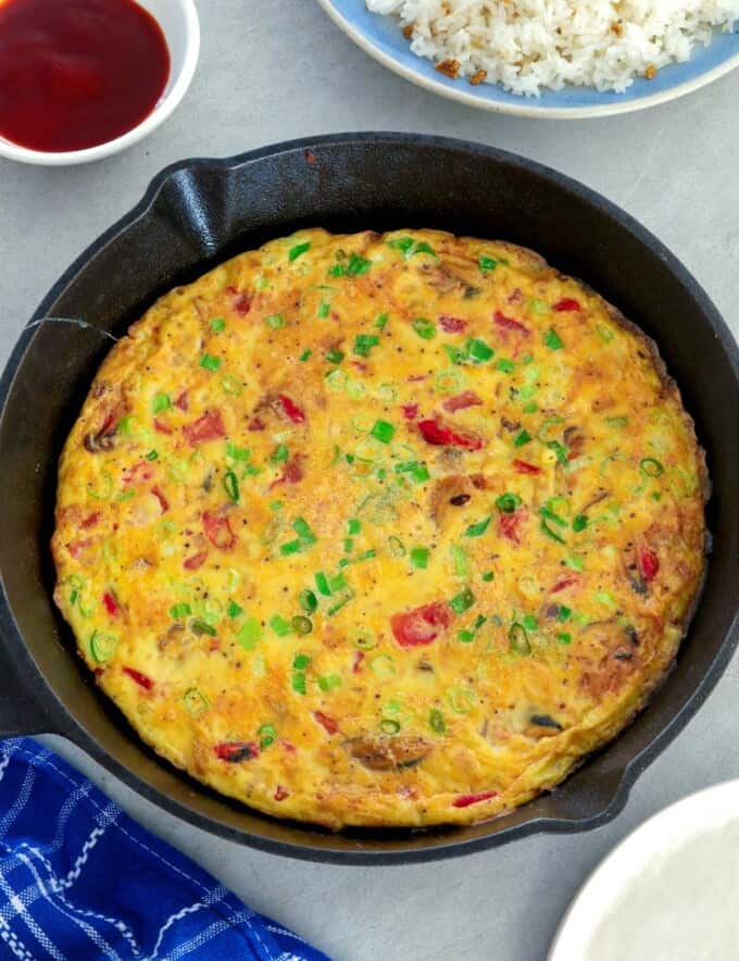 tortang tahong in a cast iron pan