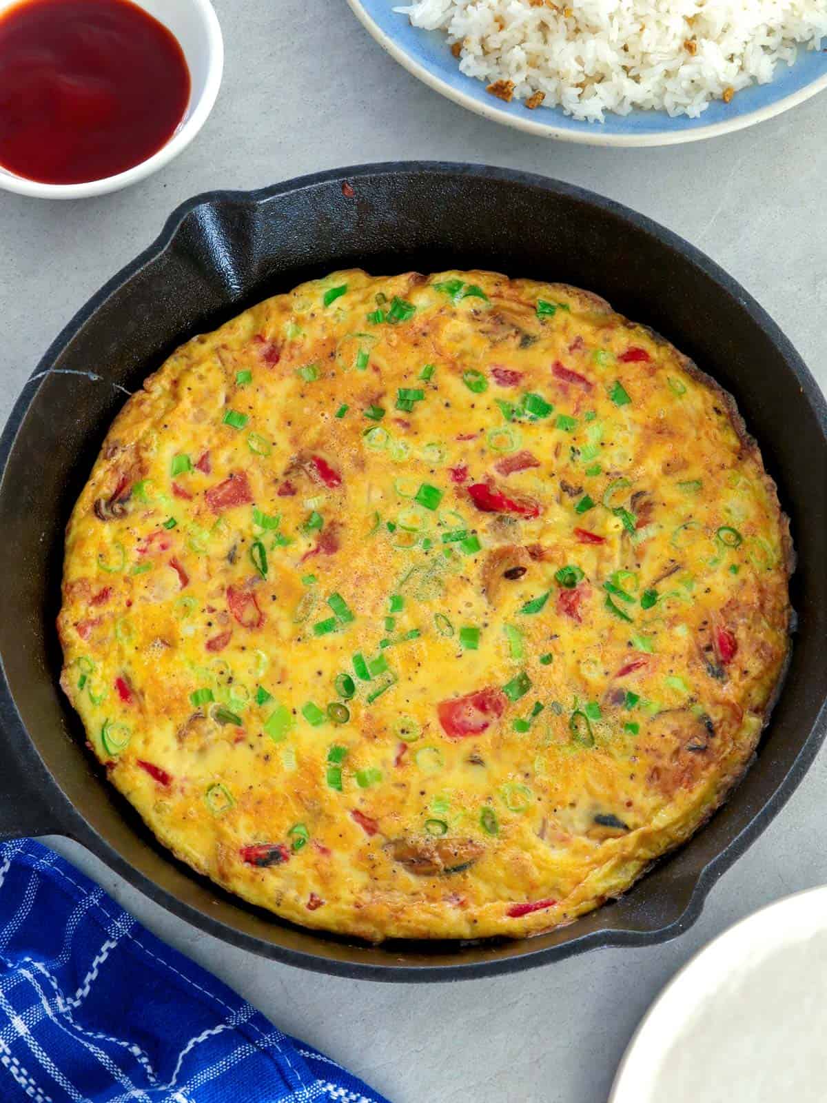 tortang tahong in a cast iron pan